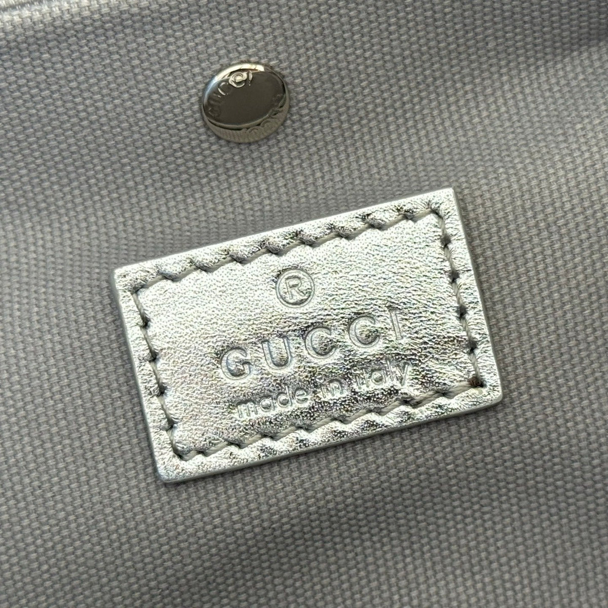 GUCCI 26S  EMBLEM BUCKET BAG 19 IN BEIGE AND SILVER CANVAS